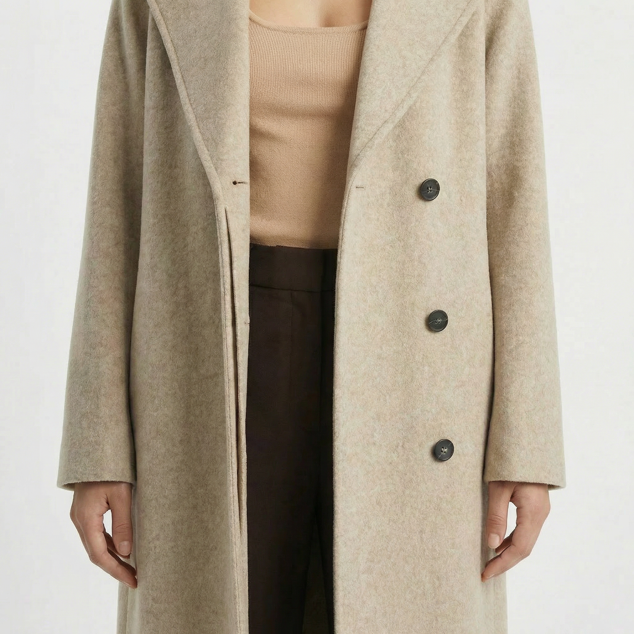 Beige coat worn by a person on a white background