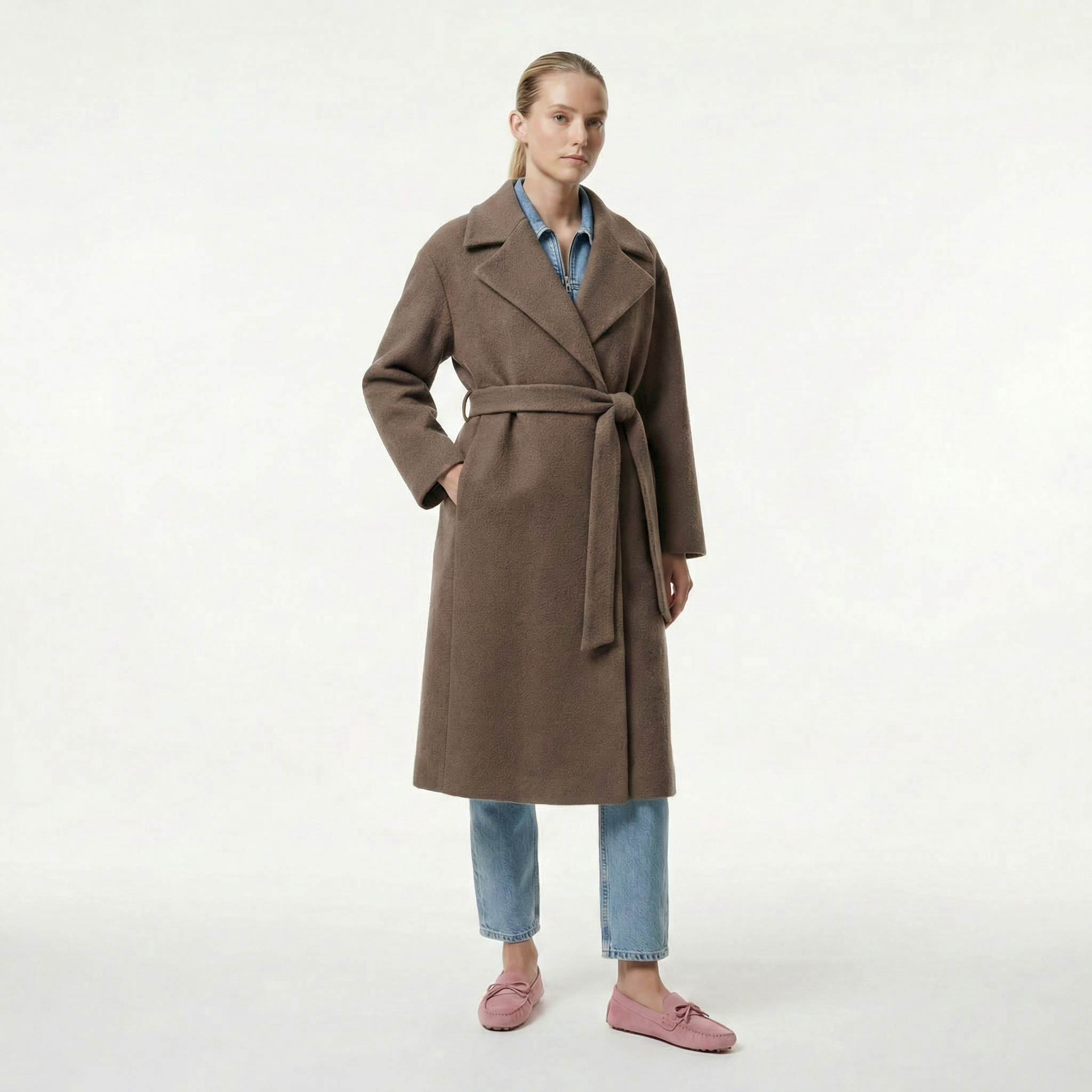 Woman wearing a brown coat on a white background