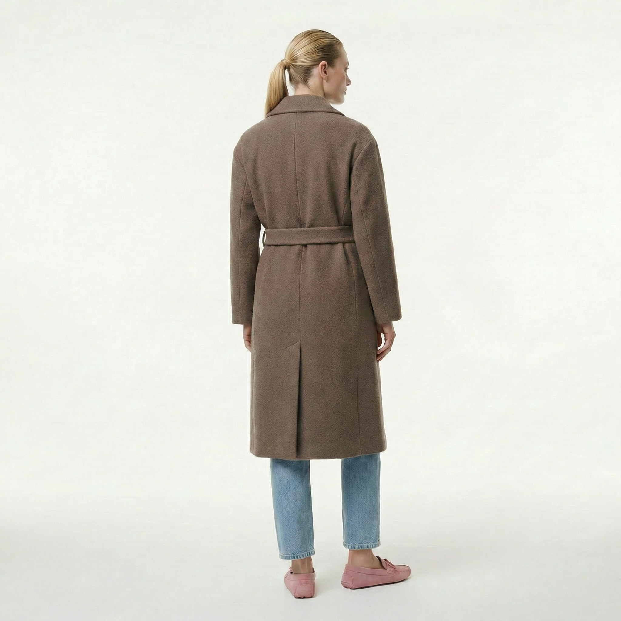 Woman wearing a brown coat on a white background